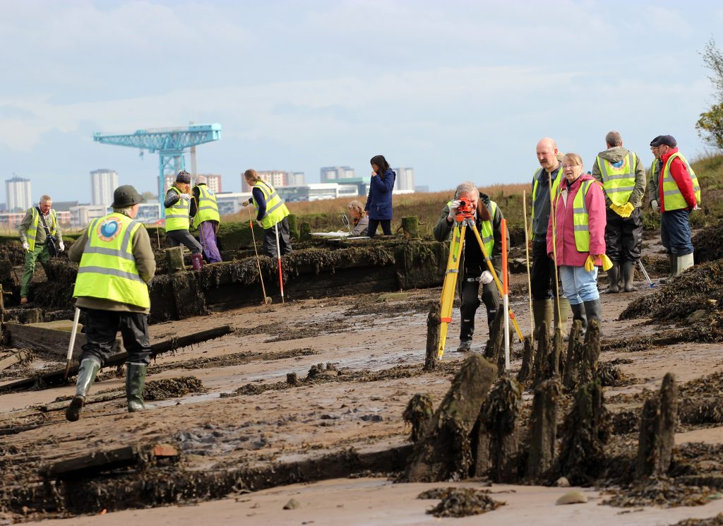 Volunteers surveying wooden wrecks on the Clyde Foreshore