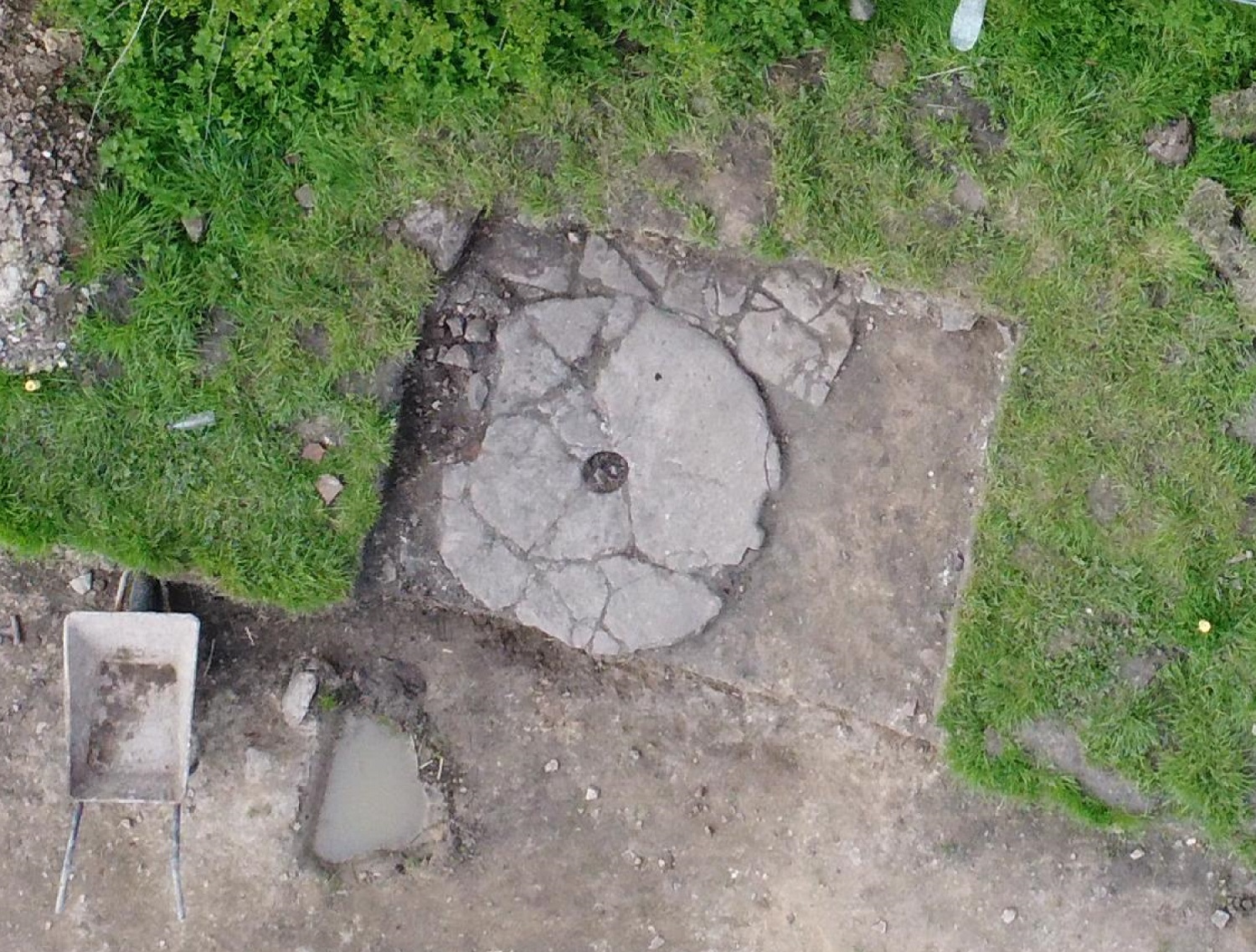 An overhead view of a circular millstone laid flat