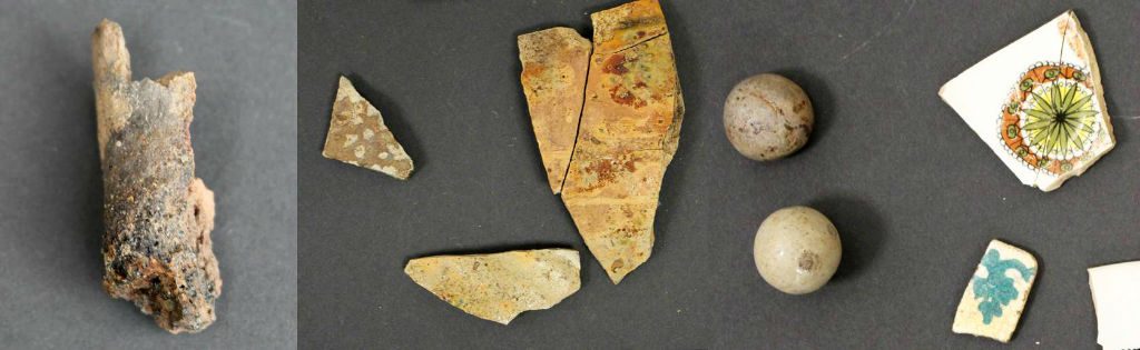 A row of 3 images showing finds. On the left, a fragment of a vitrified clay object. In the centre, medieval green-glazed pottery sherds. On the right, more recent clay marbles and decorated pottery sherds