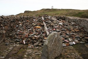 Modern pilgrim's cairn within former lifeboat station