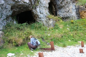 Closer view of cave and vegetated midden