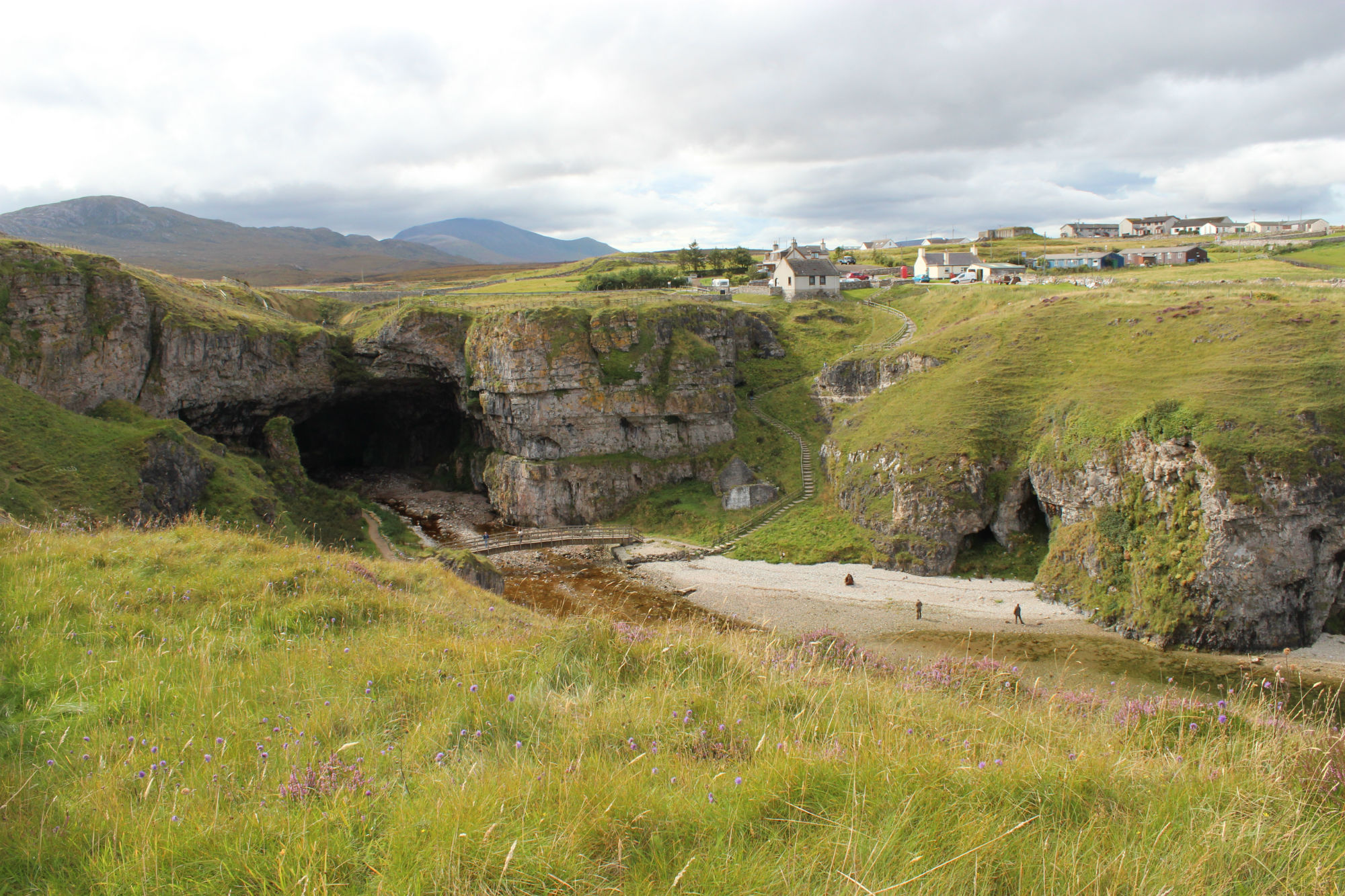 General view looking southwest towards Smoo Cave, Glass Knappers Cave on right of image