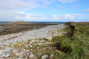 View of section looking East. Intertidal peat beneath boulders in intertidal zone. Eilean Arnol in background.