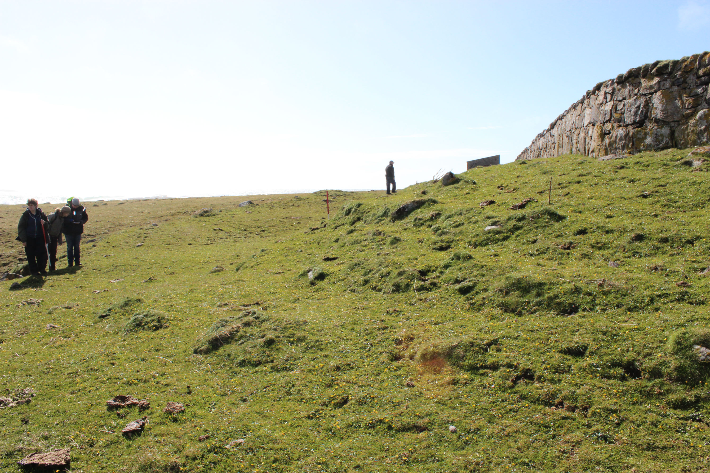 General view of the broch mound and cemetery wall