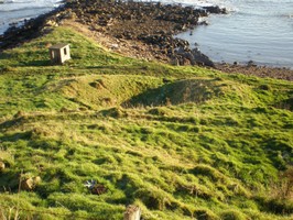 Earthworks [1484] in foreground, coastguard hut in ackground, looking SE