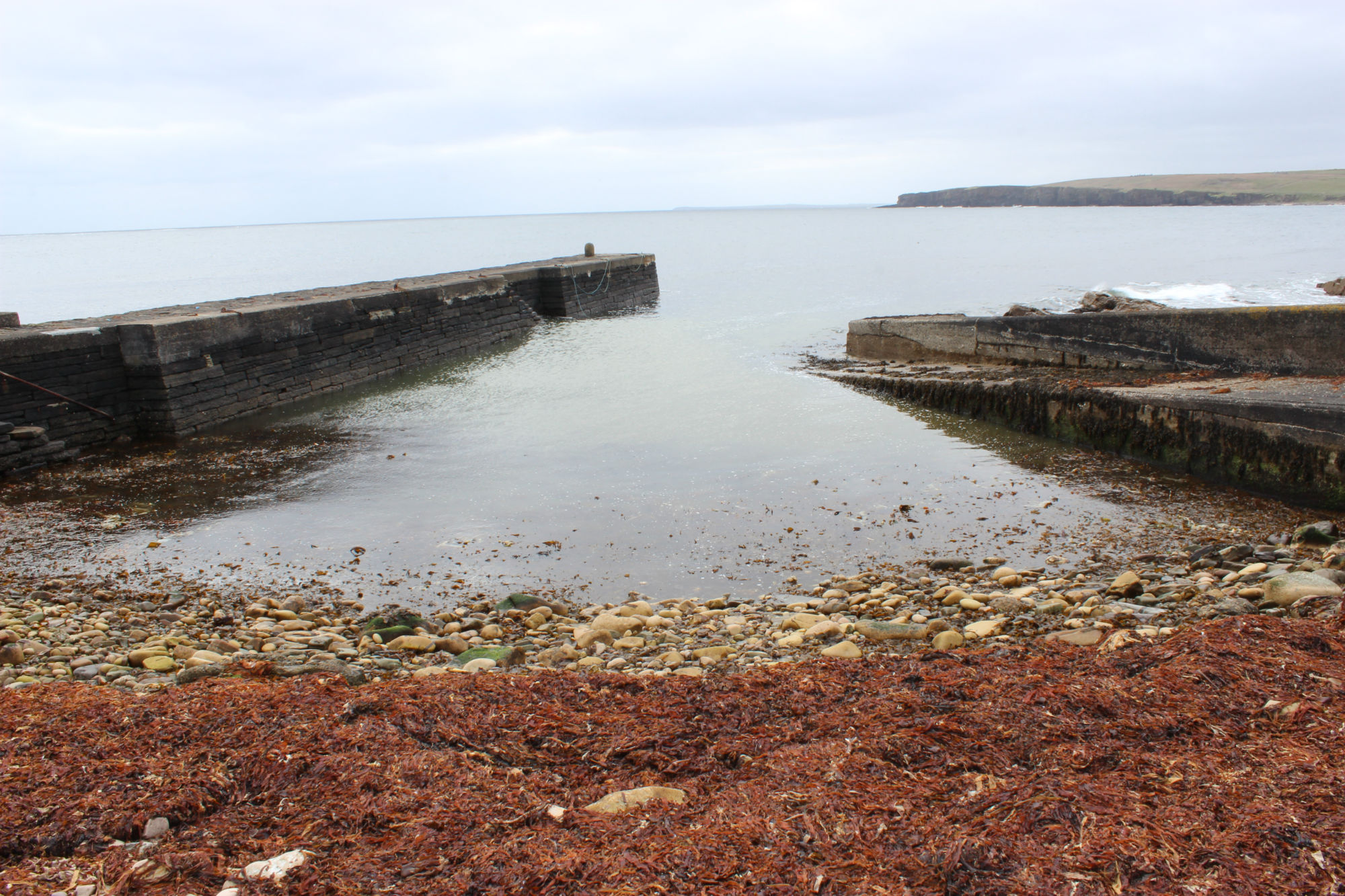 Interior of harbour, pier on left, breakwater on right