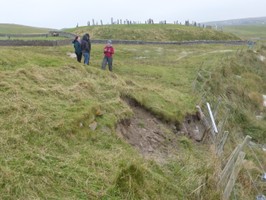 Stonework in section and eroding slope at coast edge
