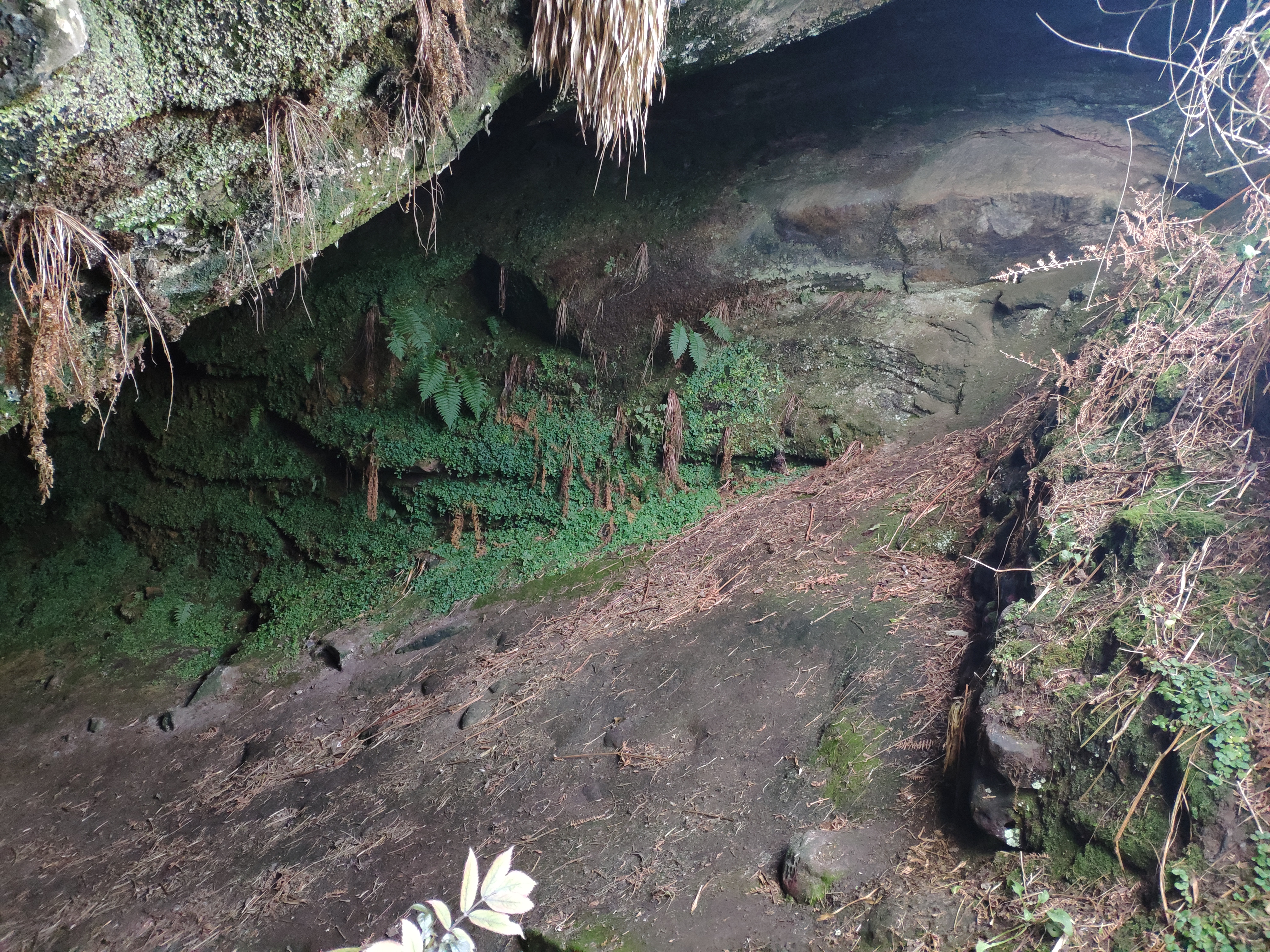 Roughly built wall at cave entrance on right