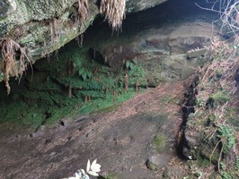 Roughly built wall at cave entrance on right