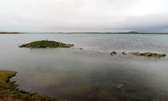 The chambered cairn at high spring tide, viewed from the south