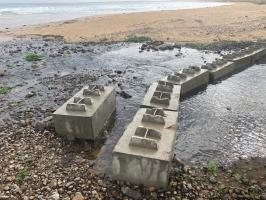 Eight concrete blocks at mouth of culvert.  Look to be more modern than WW2 anti-tank blocks.