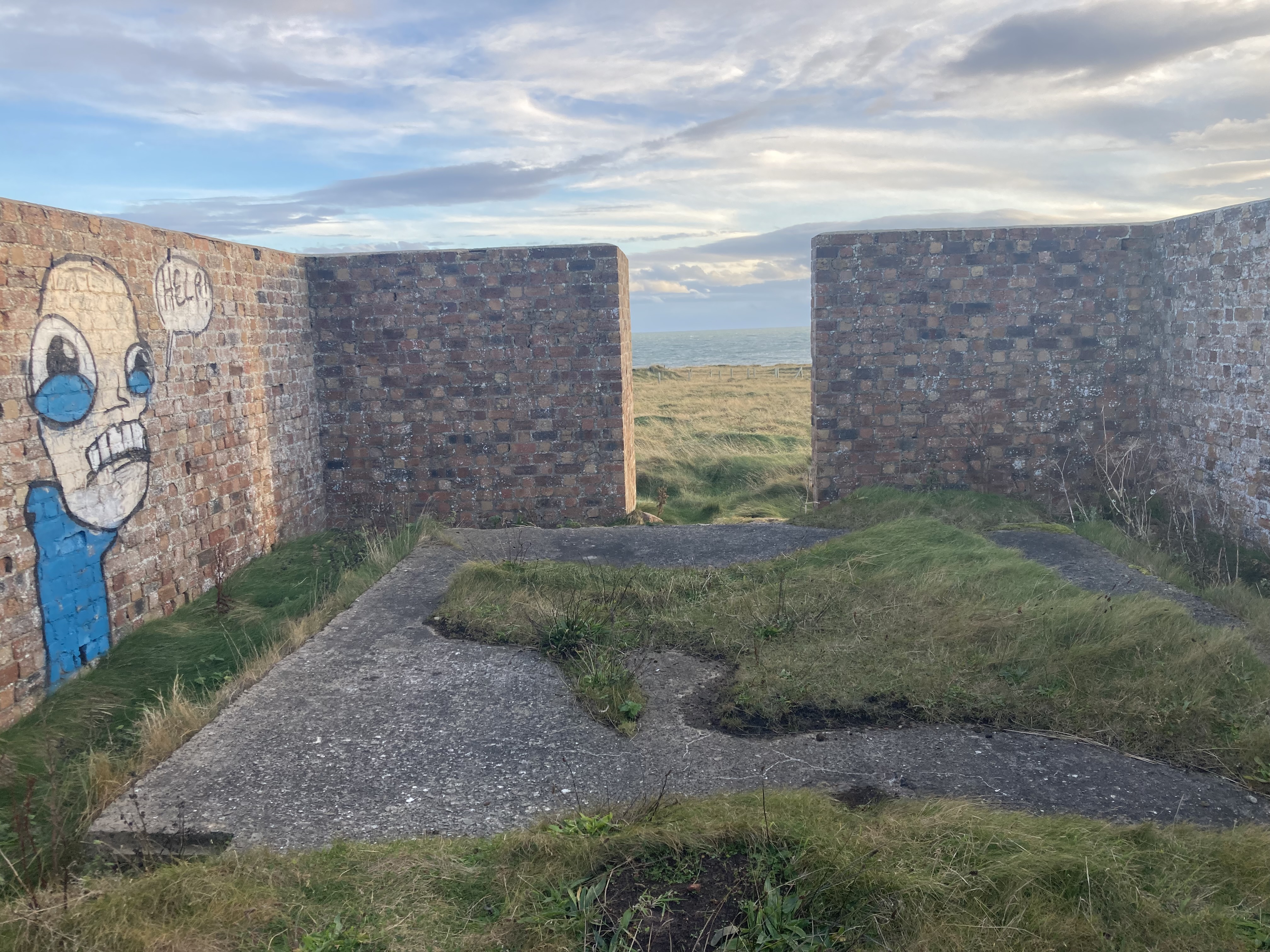 View south from inside the larger southern red brick walled enclosure.