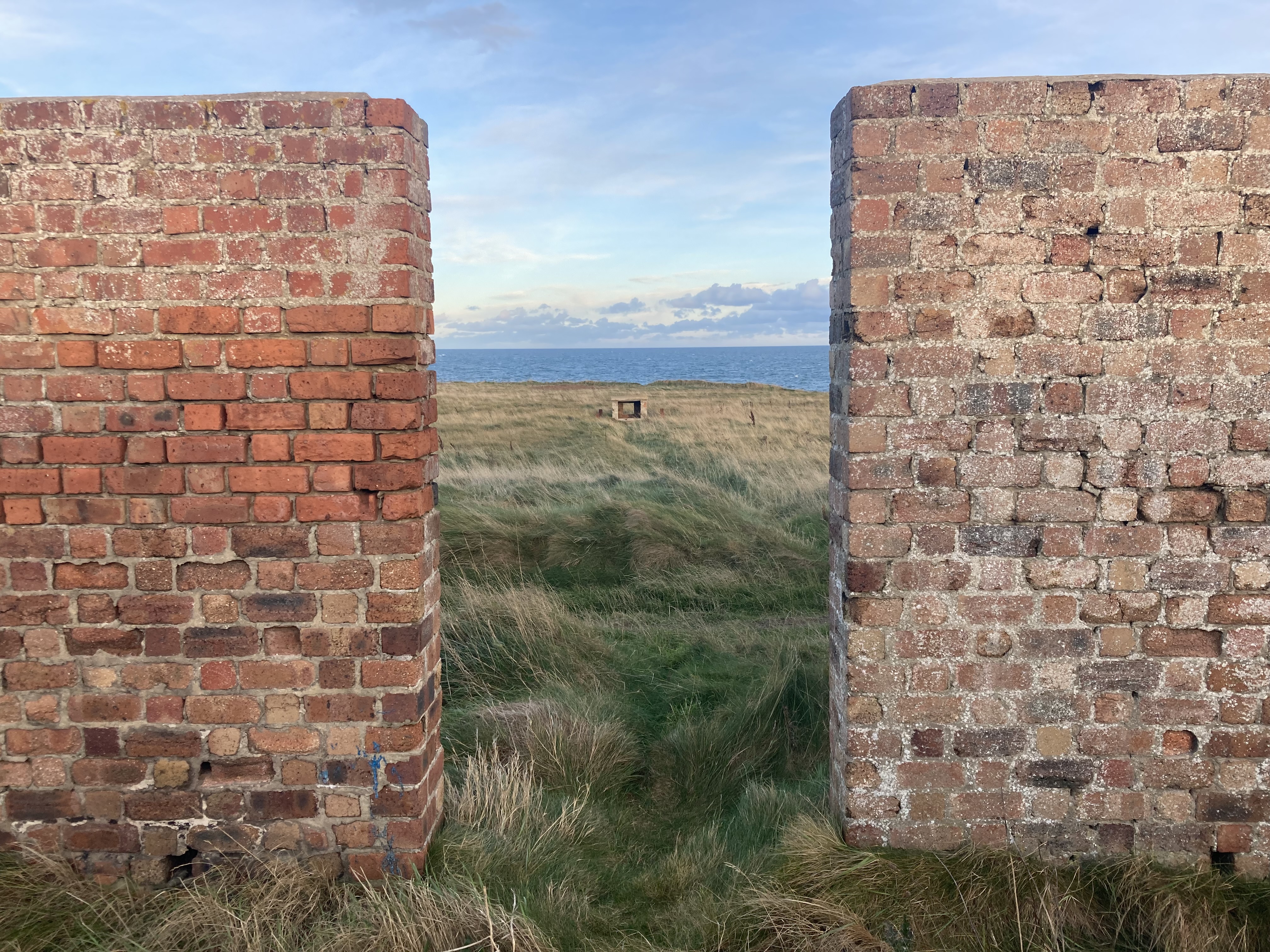 Looking east from red brick structure/enclosure towards mast base.