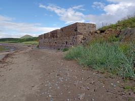 Looking NE - front of boat house with three bricked up windows.