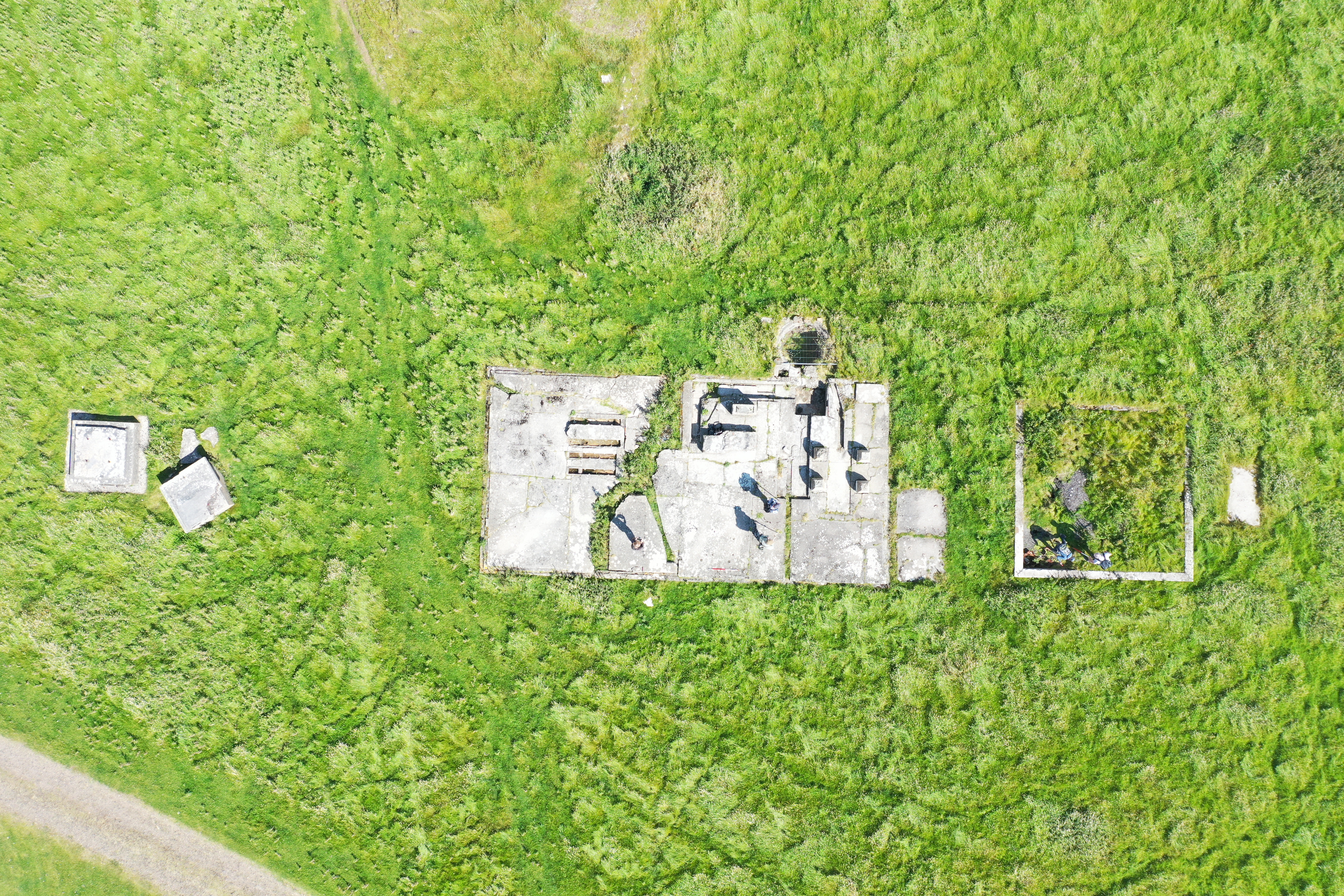 Detailed aerial shot of steam engine house, water tank and antenna base.
