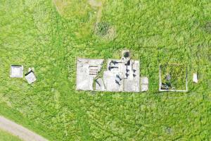 Detailed aerial shot of steam engine house, water tank and antenna base.